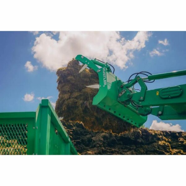 Silage Grabber raised on Tractor Loader